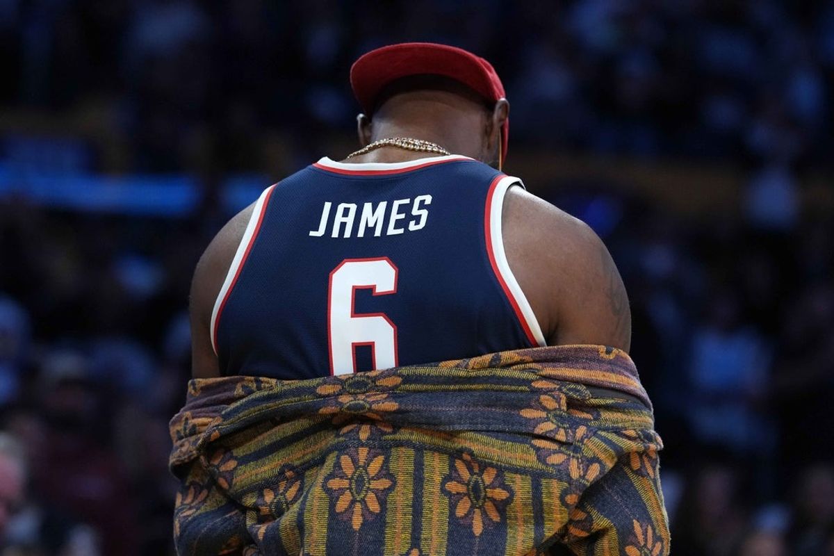Oct 24, 2025; Los Angeles, California, USA; Los Angeles Lakers forward LeBron James poses in the Arizona Wildcats jersey of his son Bryce James (6) during the game against the Minnesota Timberwolves at Crypto.com Arena. Mandatory Credit: Kirby Lee-Imagn Images