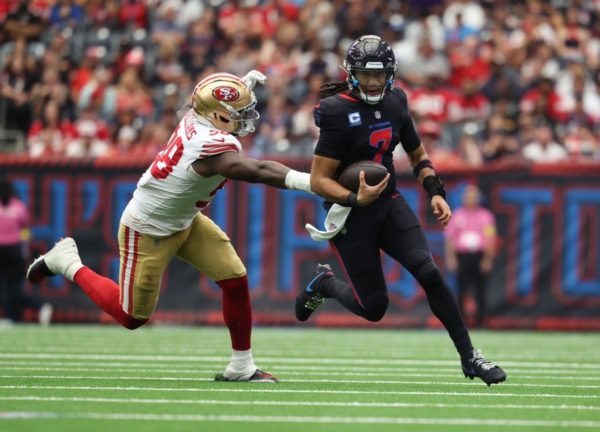 Oct 26, 2025; Houston, Texas, USA; Houston Texans quarterback C.J. Stroud (7) runs for a gain past San Francisco 49ers defensive lineman Evan Anderson (58) during the second quarter at NRG Stadium. Mandatory Credit: Troy Taormina-Imagn Images