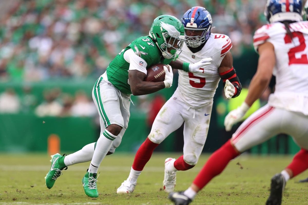 Oct 26, 2025; Philadelphia, Pennsylvania, USA; Philadelphia Eagles running back Tank Bigsby (37) runs against New York Giants linebacker Kayvon Thibodeaux (5) in the fourth quarter at Lincoln Financial Field. Mandatory Credit: Bill Streicher-Imagn Images