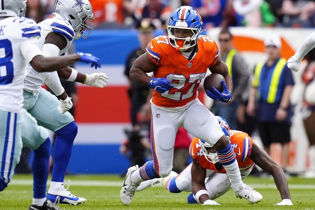 Oct 26, 2025; Denver, Colorado, USA; Denver Broncos running back J.K. Dobbins (27) runs against the Dallas Cowboys in the first half at Empower Field at Mile High. Mandatory Credit: Ron Chenoy-Imagn Images