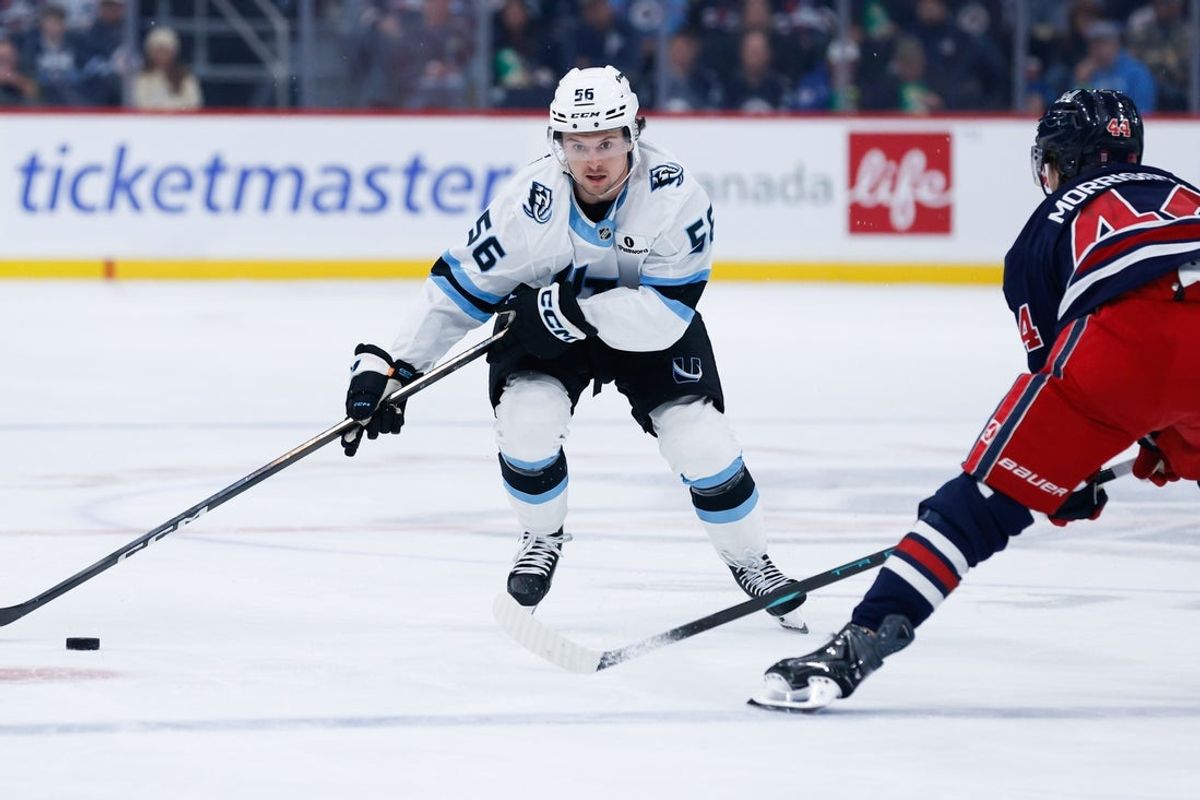 Oct 26, 2025; Winnipeg, Manitoba, CAN; Utah Mammoth forward forward Kailer Yamamoto (56) skates in on Winnipeg Jets defenseman Josh Morrissey (44) during the first period at Canada Life Centre. Mandatory Credit: Terrence Lee-Imagn Images