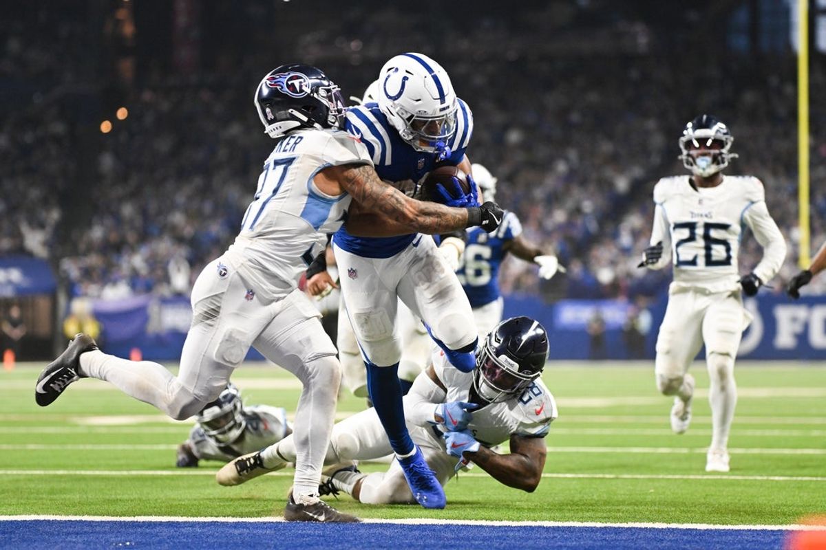 Oct 26, 2025; Indianapolis, Indiana, USA; Indianapolis Colts running back Jonathan Taylor (28) rushes for a touchdown as Tennessee Titans safety Amani Hooker (37) defends during the third quarter at Lucas Oil Stadium. Mandatory Credit: Robert Goddin-Imagn Images