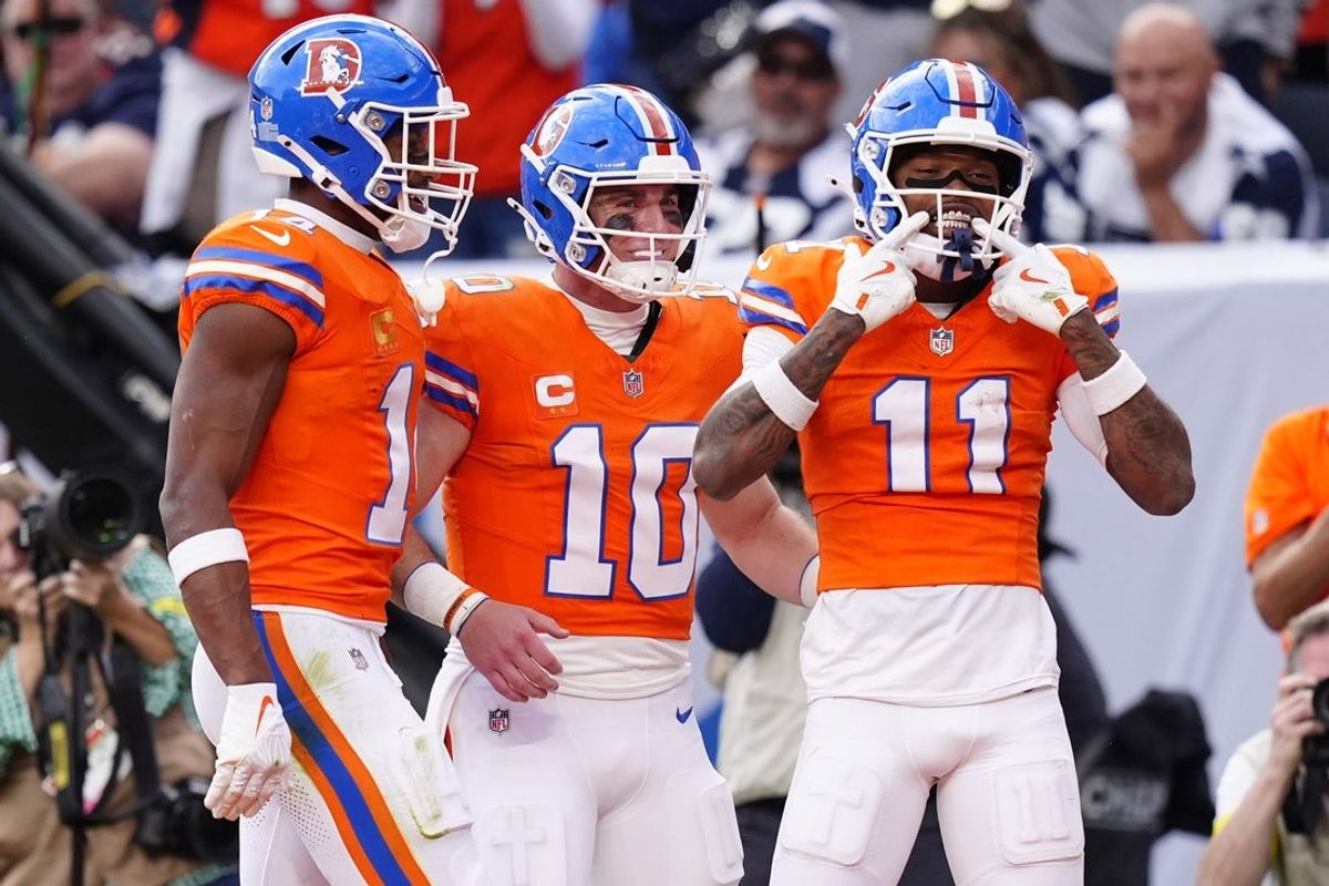 Oct 26, 2025; Denver, Colorado, USA;  Denver Broncos wide receiver Troy Franklin (11) celebrates with wide receiver Courtland Sutton (14) and quarterback Bo Nix (10) after scoring a touchdown against the Dallas Cowboys in the fourth quarter at Empower Field at Mile High. Mandatory Credit: Ron Chenoy-Imagn Images