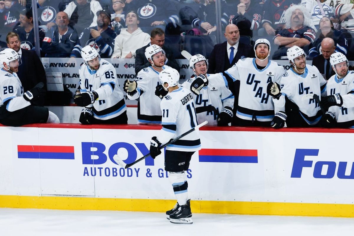 Oct 26, 2025; Winnipeg, Manitoba, CAN; Utah Mammoth forward forward Dylan Guenther (11) is congratulated by his team mates on his goal against the Winnipeg Jets during the third period at Canada Life Centre. Mandatory Credit: Terrence Lee-Imagn Images