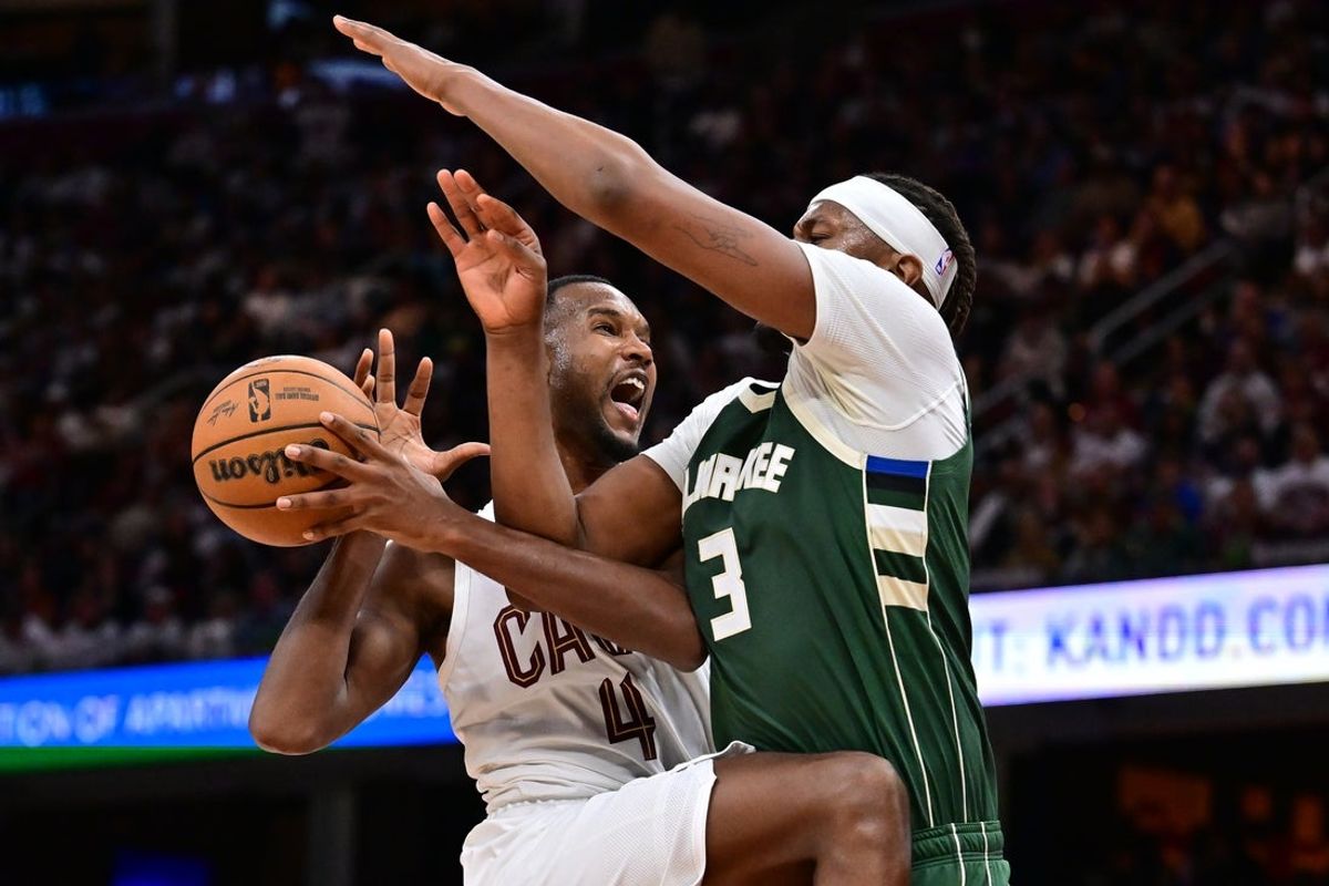 Oct 26, 2025; Cleveland, Ohio, USA; Cleveland Cavaliers center Evan Mobley (4) drives to the basket against Milwaukee Bucks center Myles Turner (3) during the second half at Rocket Arena. Mandatory Credit: Ken Blaze-Imagn Images
