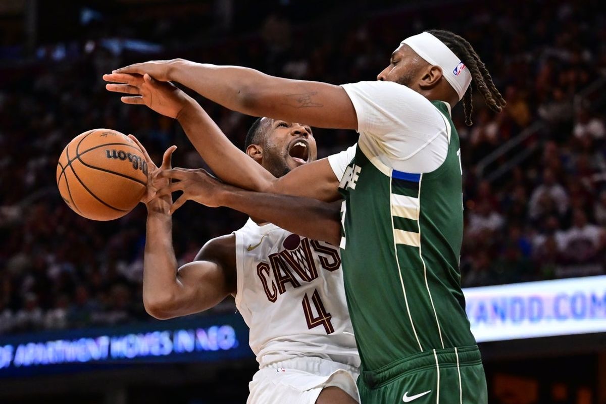 Oct 26, 2025; Cleveland, Ohio, USA; Cleveland Cavaliers center Evan Mobley (4) drives to the basket against Milwaukee Bucks center Myles Turner (3) during the second half at Rocket Arena. Mandatory Credit: Ken Blaze-Imagn Images