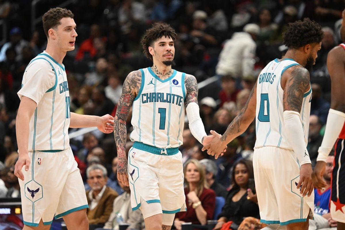 Oct 26, 2025; Washington, District of Columbia, USA; Charlotte Hornets guard LaMelo Ball (1) celebrates with center Ryan Kalkbrenner (11) and forward Miles Bridges (0) against the Washington Wizards during the fourth quarter at Capital One Arena. Mandatory Credit: Rafael Suanes-Imagn Images