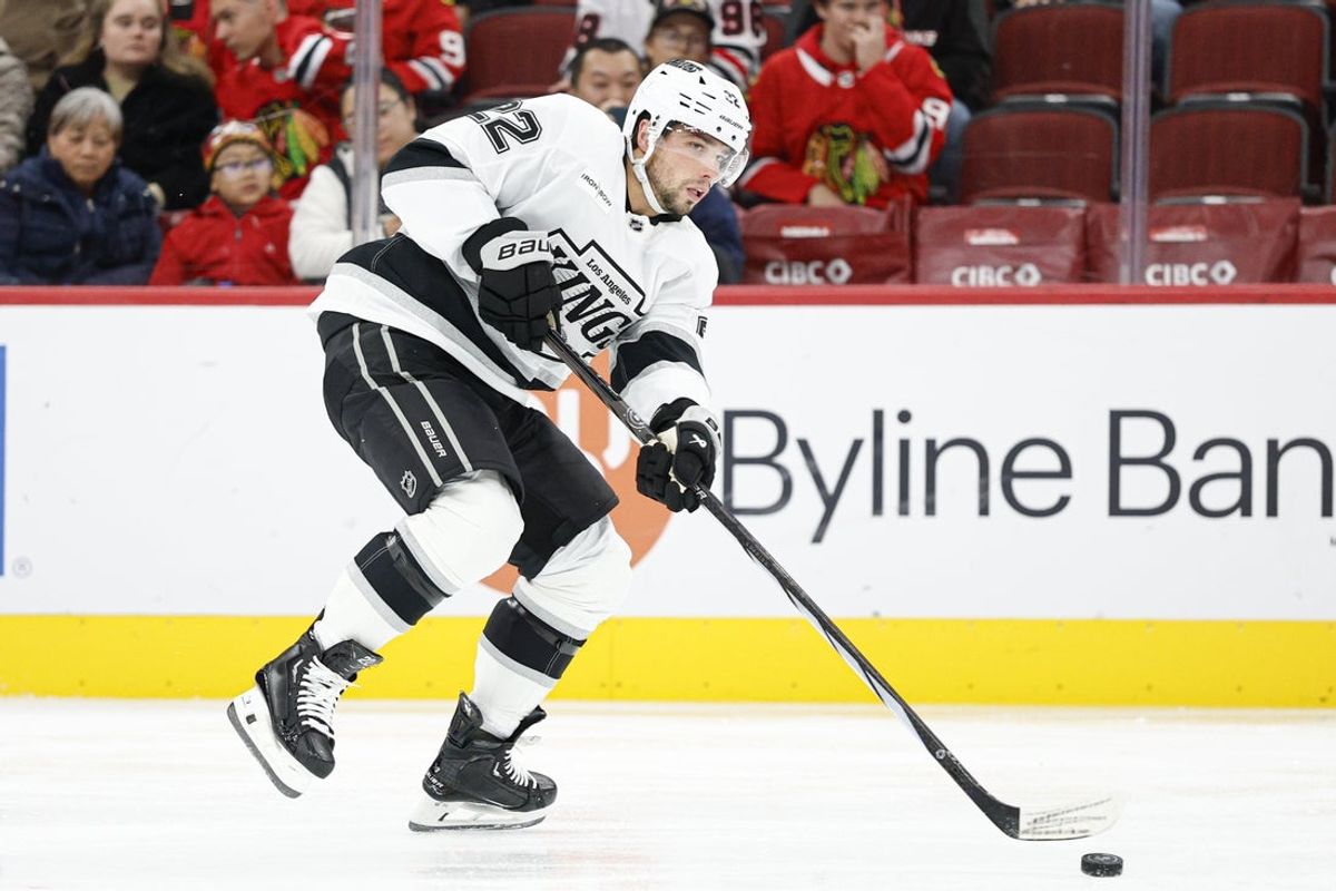 Oct 26, 2025; Chicago, Illinois, USA; Los Angeles Kings left wing Kevin Fiala (22) passes the puck against the Chicago Blackhawks during the first period at United Center. Mandatory Credit: Kamil Krzaczynski-Imagn Images