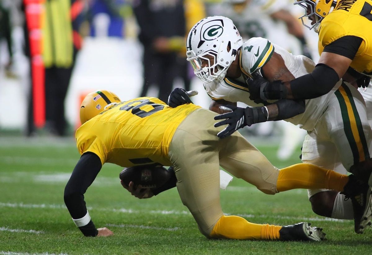 Pittsburgh Steelers quarterback Aaron Rodgers (8) gets sacked by Green Bay Packers defensive end Micah Parsons (1) during the second half at Acrisure Stadium in Pittsburgh, PA on October 26, 2025.