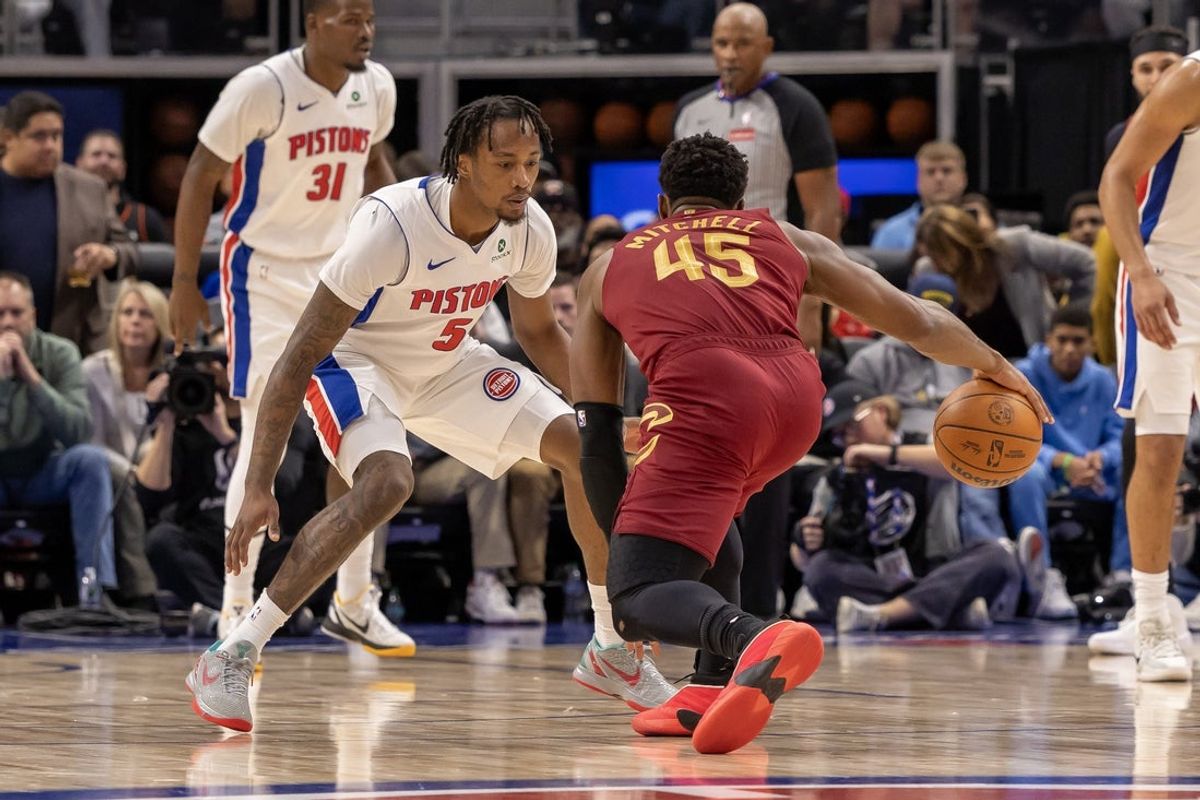 Oct 27, 2025; Detroit, Michigan, USA; Detroit Pistons forward Ronald Holland II (5) defends against Cleveland Cavaliers guard Donovan Mitchell (45) during the first half at Little Caesars Arena. Mandatory Credit: David Reginek-Imagn Images