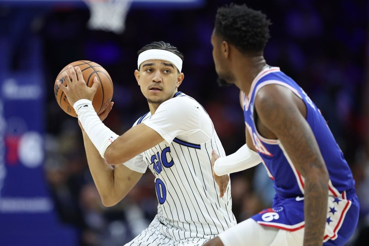 Oct 27, 2025; Philadelphia, Pennsylvania, USA; Orlando Magic guard Anthony Black (0) controls the ball against Philadelphia 76ers forward Justin Edwards (11) during the second quarter at Xfinity Mobile Arena. Mandatory Credit: Bill Streicher-Imagn Images