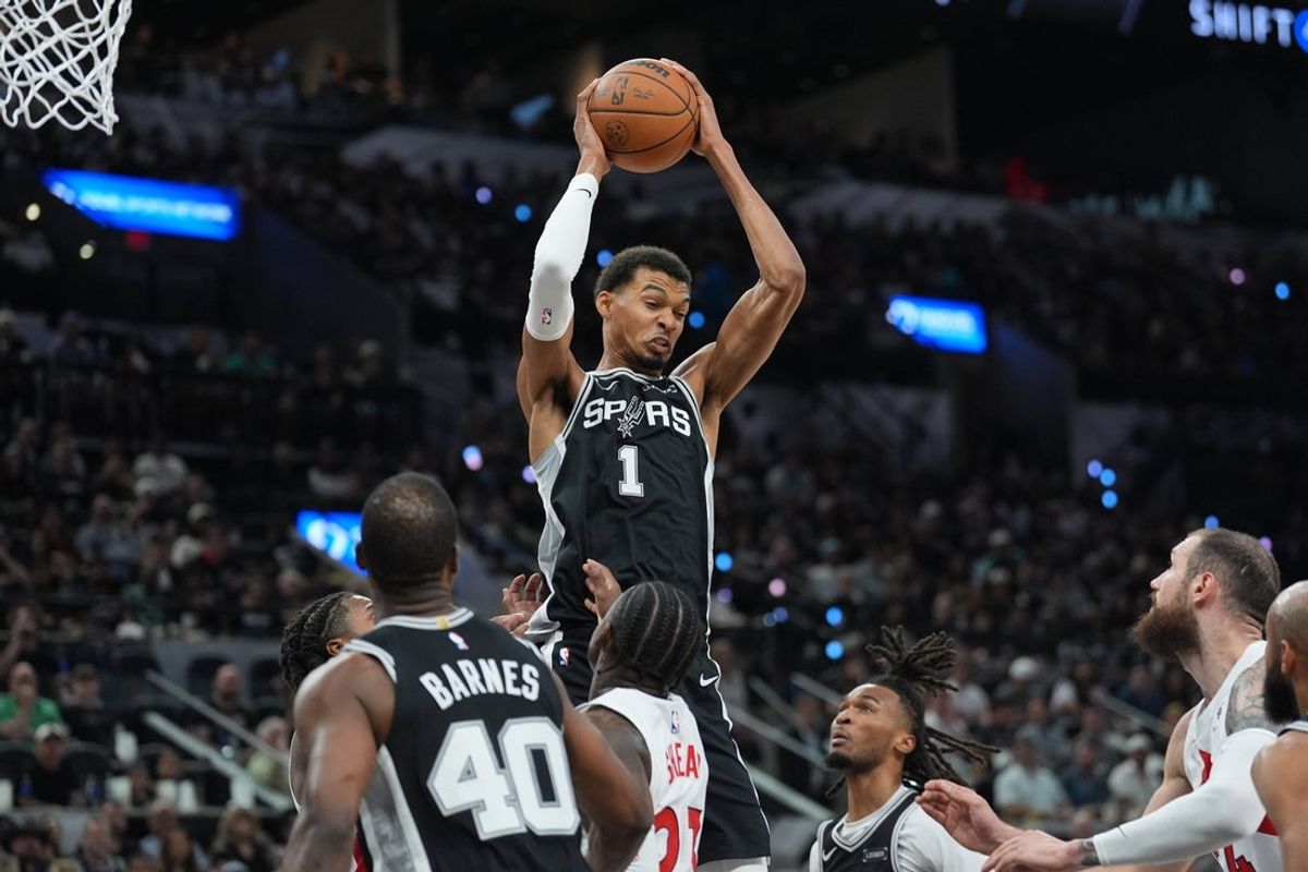 Oct 27, 2025; San Antonio, Texas, USA;  San Antonio Spurs forward/center Victor Wembanyama (1) rebounds in the first half against the Toronto Raptors at Frost Bank Center. Mandatory Credit: Daniel Dunn-Imagn Images