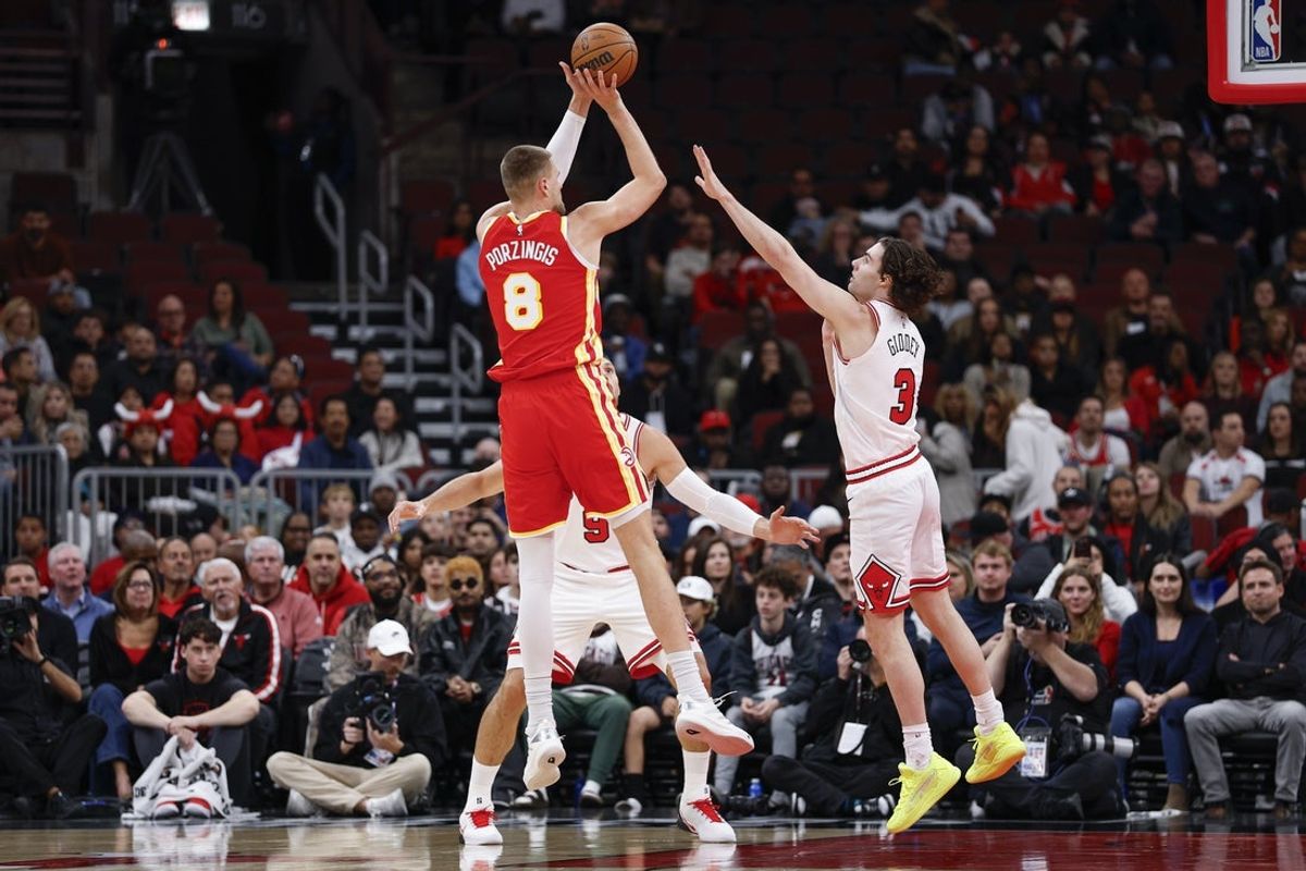 Oct 27, 2025; Chicago, Illinois, USA; Atlanta Hawks center Kristaps Porzingis (8) shoots against Chicago Bulls guard Josh Giddey (3) during the first half at United Center. Mandatory Credit: Kamil Krzaczynski-Imagn Images