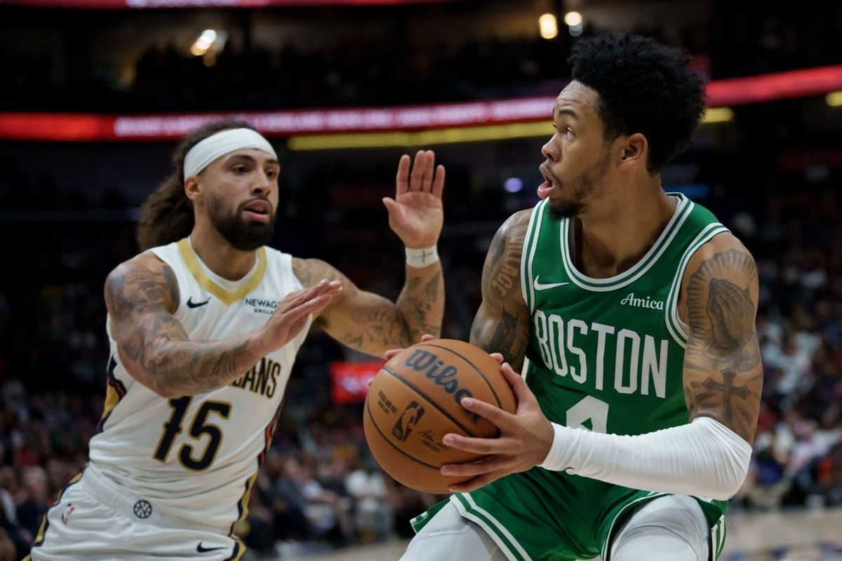 Oct 27, 2025; New Orleans, Louisiana, USA; Boston Celtics guard Anfernee Simons (4) shoots against New Orleans Pelicans guard Jose Alvarado (15) during the first half at Smoothie King Center. Mandatory Credit: Matthew Hinton-Imagn Images