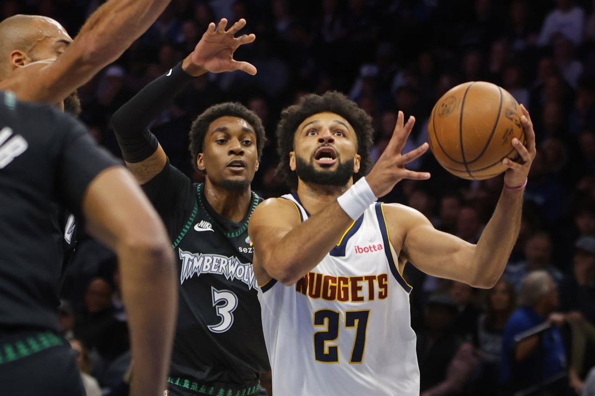 Oct 27, 2025; Minneapolis, Minnesota, USA; Denver Nuggets guard Jamal Murray (27) goes to the basket past Minnesota Timberwolves forward Jaden McDaniels (3) in the first quarter at Target Center. Mandatory Credit: Bruce Kluckhohn-Imagn Images