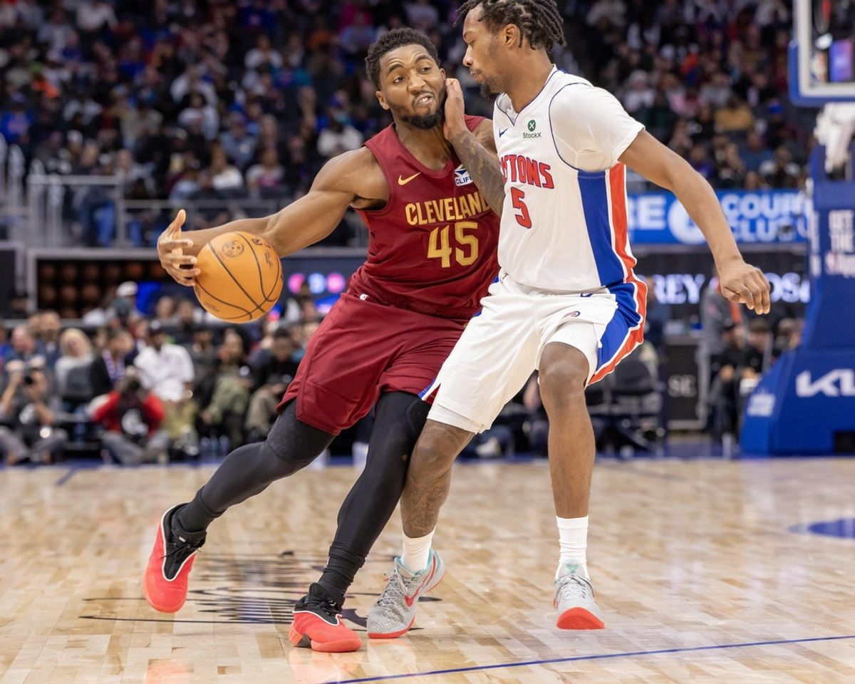 Oct 27, 2025; Detroit, Michigan, USA; Detroit Pistons forward Ronald Holland II (5) defends against Cleveland Cavaliers guard Donovan Mitchell (45) during the second half at Little Caesars Arena. Mandatory Credit: David Reginek-Imagn Images
