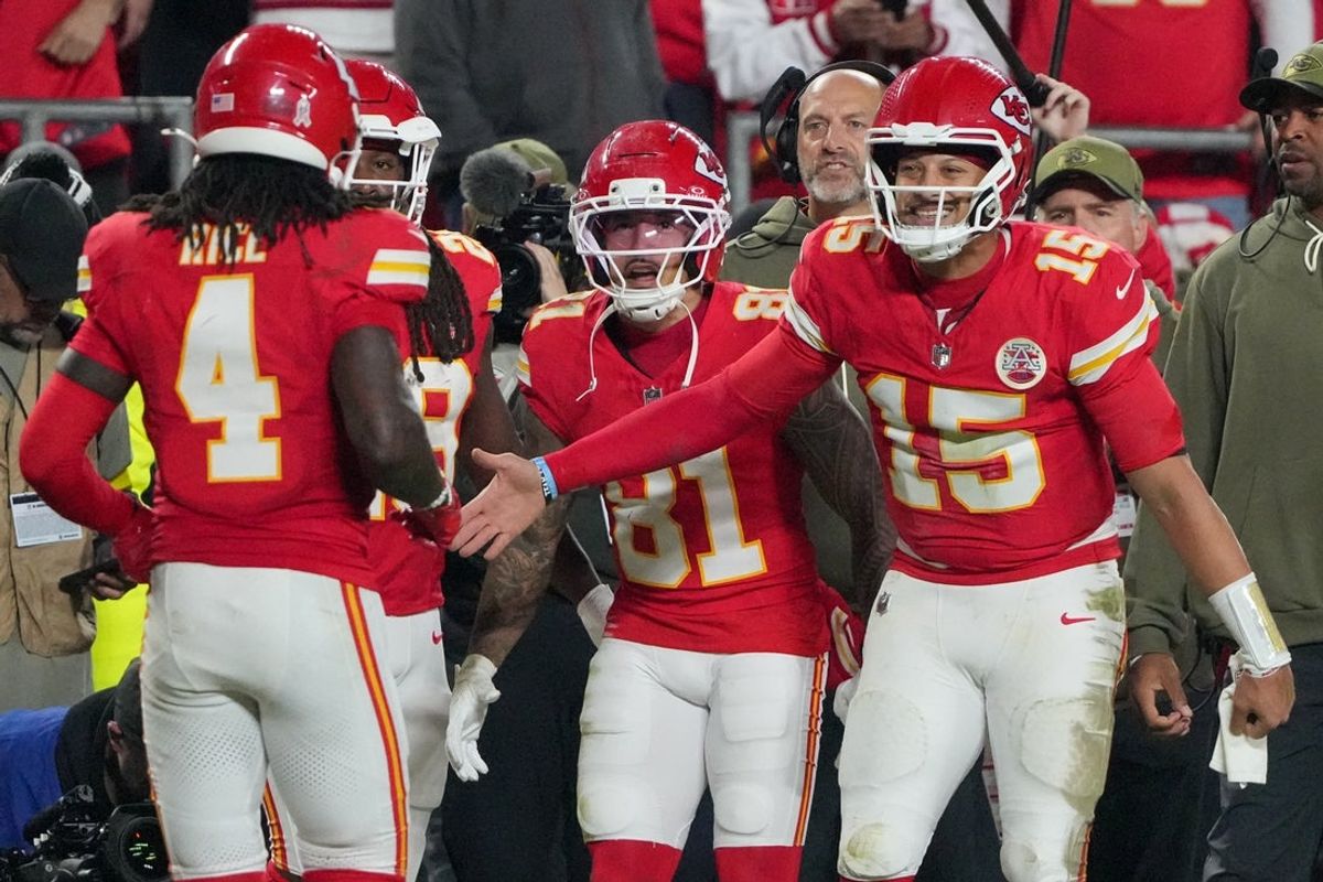 Oct 27, 2025; Kansas City, Missouri, USA; Kansas City Chiefs wide receiver Rashee Rice (4) celebrates after scoring a touchdown against the Washington Commanders with quarterback Patrick Mahomes (15) during the fourth quarter of the game at GEHA Field at Arrowhead Stadium. Mandatory Credit: Denny Medley-Imagn Images