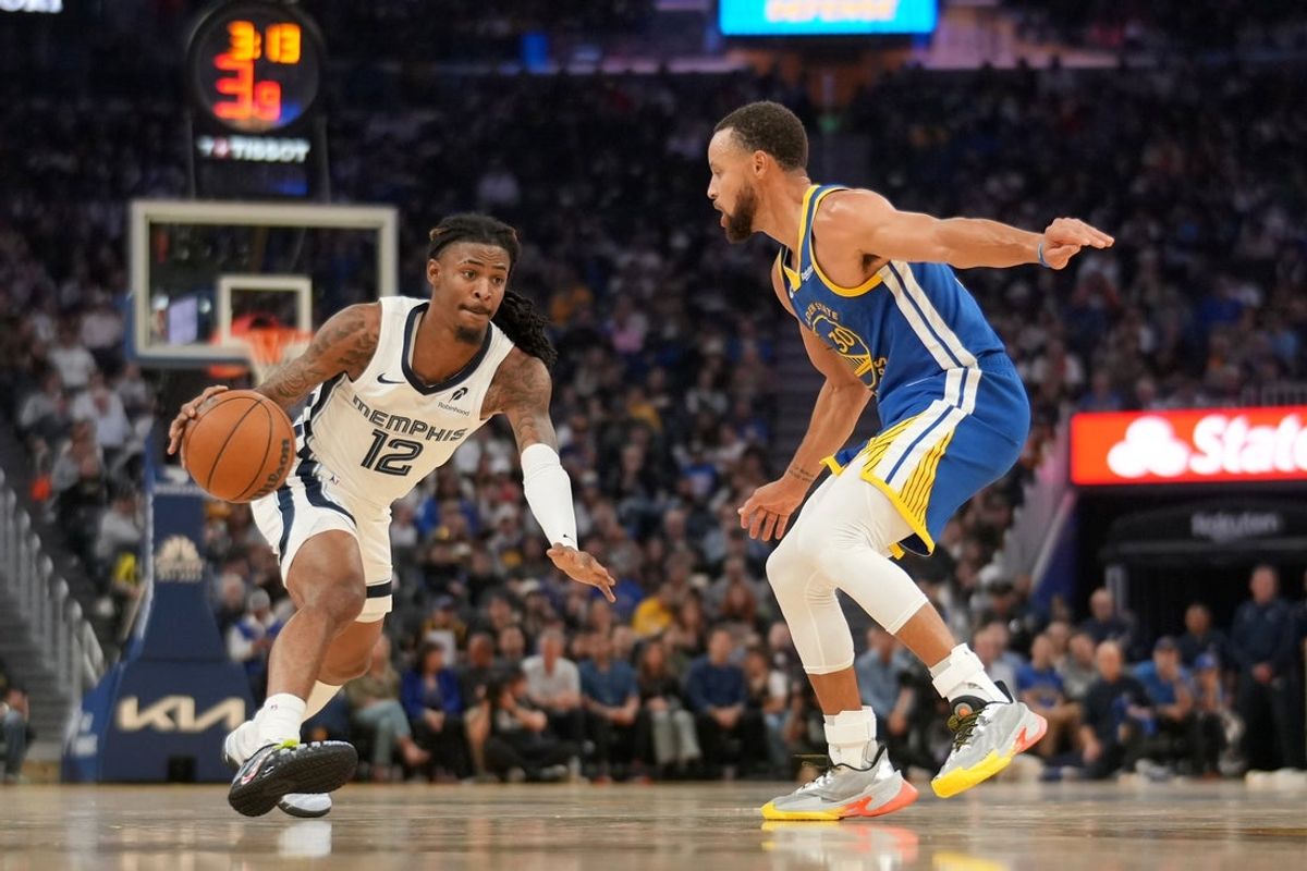 Oct 27, 2025; San Francisco, California, USA; Memphis Grizzlies guard Ja Morant (12) dribbles the ball against Golden State Warriors guard Stephen Curry (30) in the second quarter at the Chase Center. Mandatory Credit: Cary Edmondson-Imagn Images