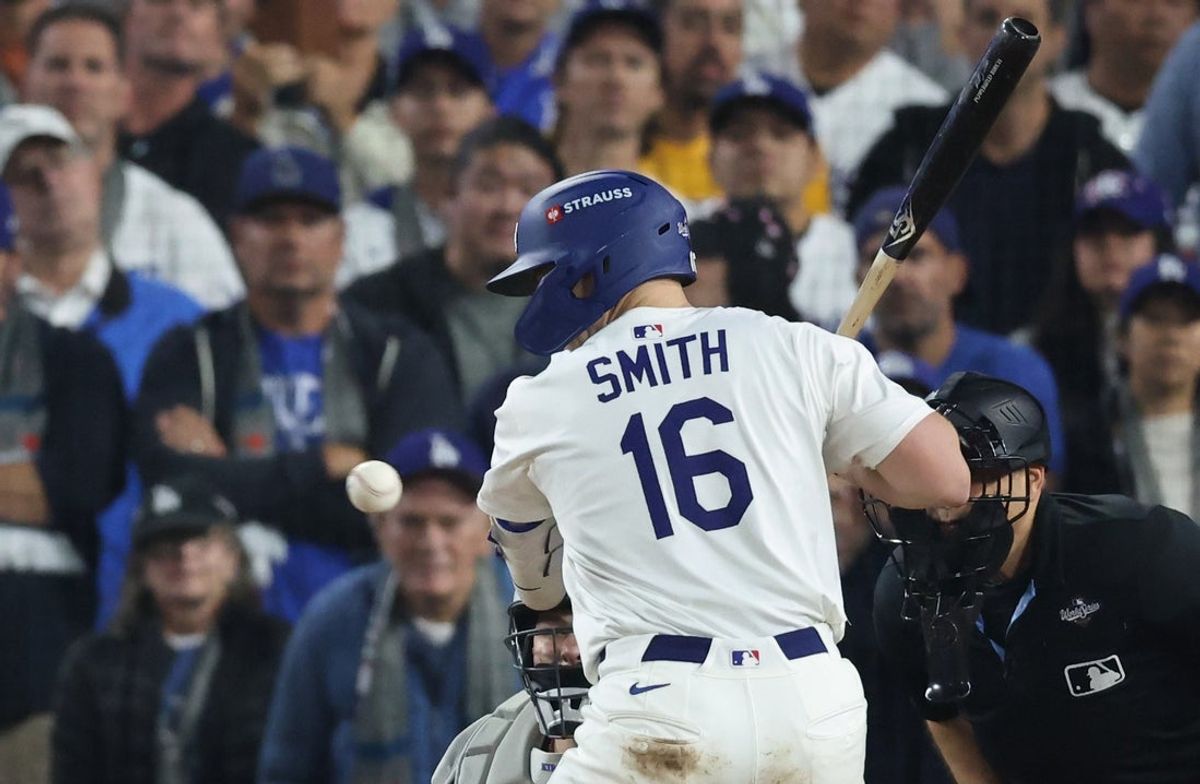 Oct 27, 2025; Los Angeles, California, USA; Los Angeles Dodgers catcher Will Smith (16) is hit by a pitch during the tenth inning against the Toronto Blue Jays in game three of the 2025 MLB World Series at Dodger Stadium. Mandatory Credit: Kiyoshi Mio-Imagn Images