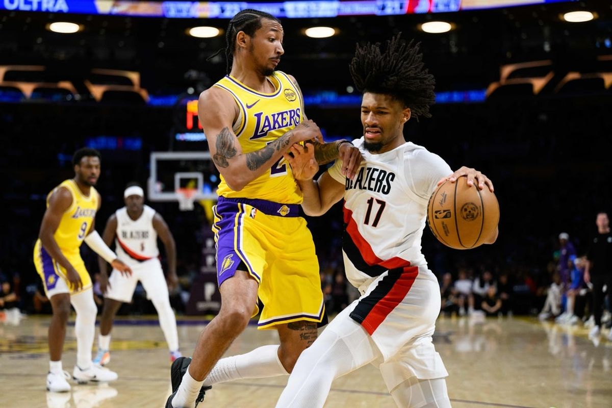 Oct 27, 2025; Los Angeles, California, USA; Portland Trail Blazers guard Shaedon Sharpe (17) drives the ball while under pressure from Los Angeles Lakers guard Nick Smith Jr. (20)during the first half at Crypto.com Arena. Mandatory Credit: William Liang-Imagn Images