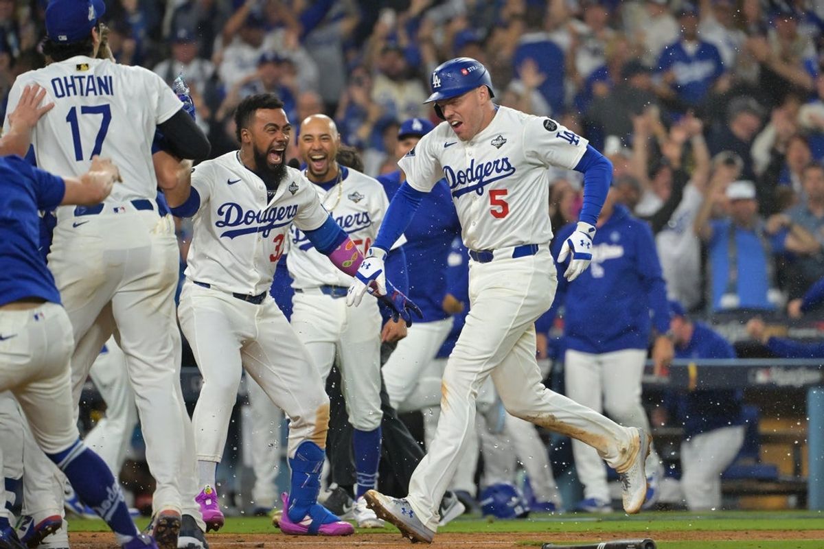 Oct 27, 2025; Los Angeles, California, USA; Los Angeles Dodgers first baseman Freddie Freeman (5) celebrates with teammates after hitting a walk off home run against the Toronto Blue Jays in the eighteenth inning during game three of the 2025 MLB World Series at Dodger Stadium. Mandatory Credit: Jayne Kamin-Oncea-Imagn Images