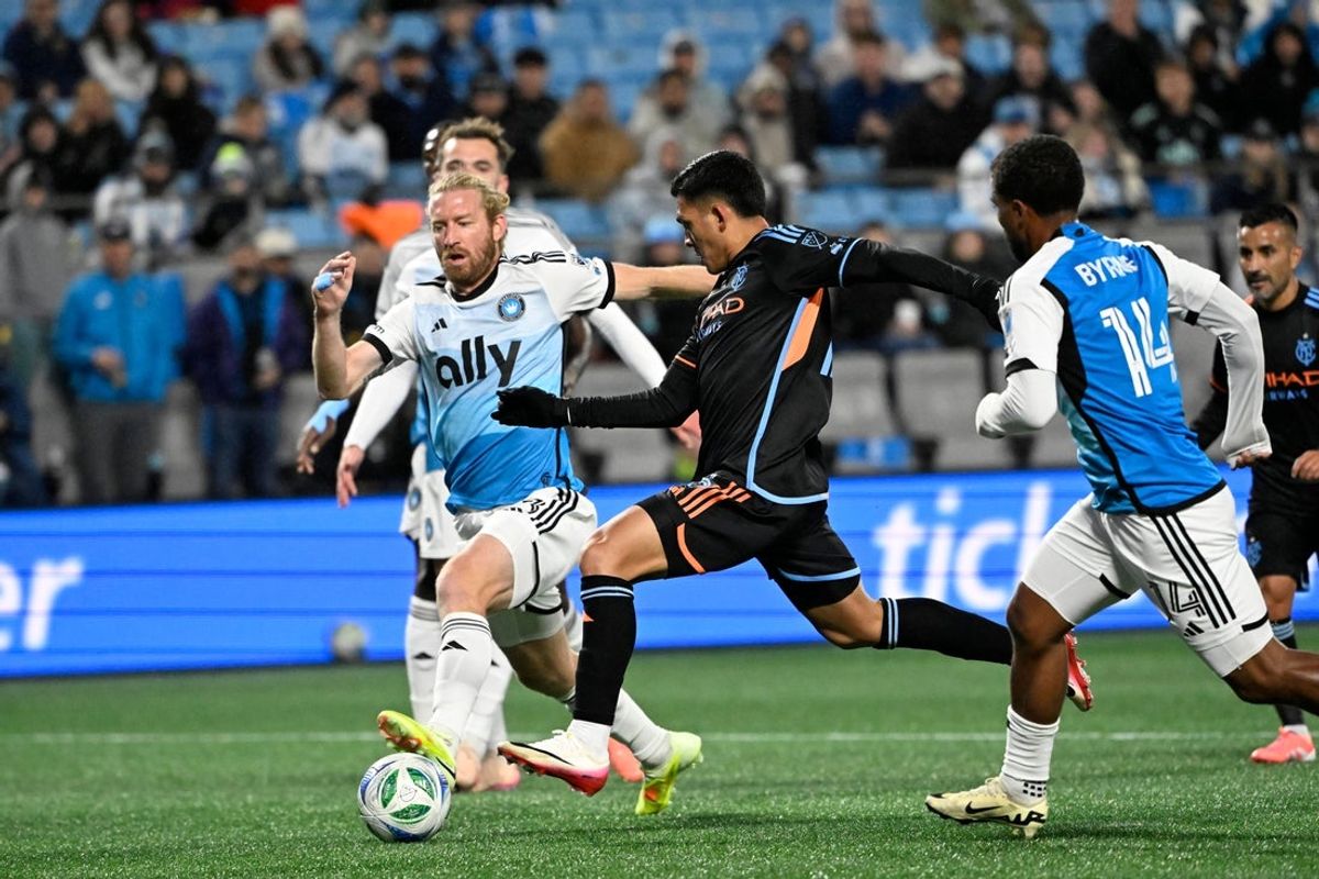 Oct 28, 2025; Charlotte, North Carolina, USA;  New York City forward Alonso Martinez (16) scores a goal as Charlotte FC defenders Tim Ream (3) and Nathan Byrne (14) defend in the first half at Bank of America Stadium. Mandatory Credit: Bob Donnan-Imagn Images