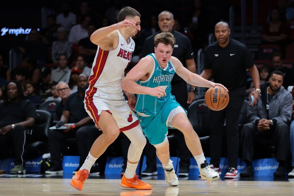 Oct 28, 2025; Miami, Florida, USA; Charlotte Hornets guard Kon Knueppel (7) drives to the basket against Miami Heat forward Nikola Jovic (5) during the second quarter at Kaseya Center. Mandatory Credit: Sam Navarro-Imagn Images