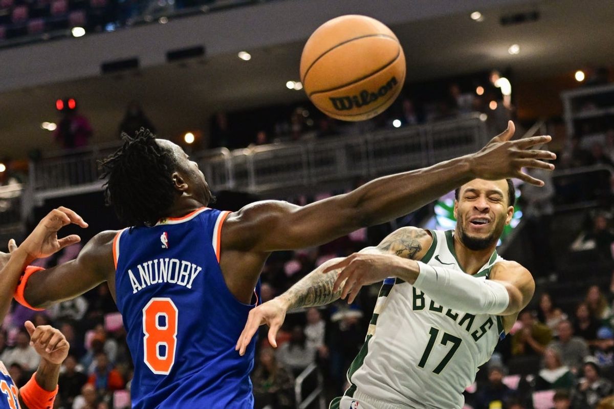 Oct 28, 2025; Milwaukee, Wisconsin, USA; Milwaukee Bucks forward Amir Coffey (17) gets a pass away from New York Knicks forward OG Anunoby (8) in the second quarter at Fiserv Forum. Mandatory Credit: Benny Sieu-Imagn Images