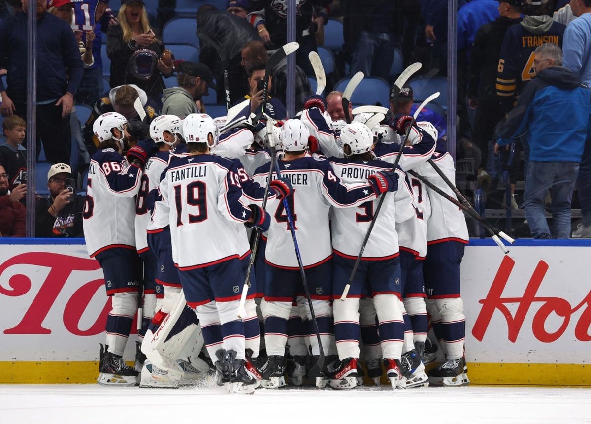 Oct 28, 2025; Buffalo, New York, USA;  The Columbus Blue Jackets celebrate an overtime win against the Buffalo Sabres at KeyBank Center. Mandatory Credit: Timothy T. Ludwig-Imagn Images