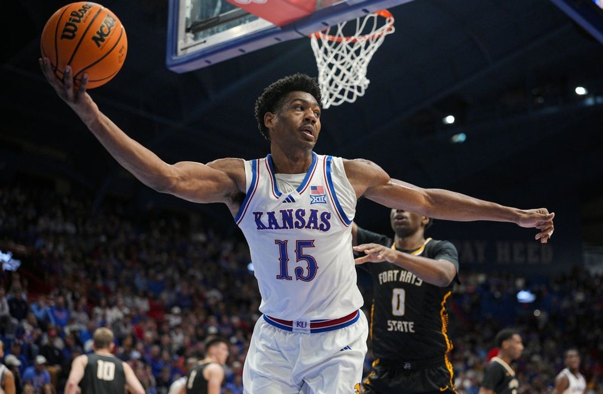 Oct 28, 2025; Lawrence, KS, USA; Kansas Jayhawks forward Bryson Tiller (15) saves the ball during the second half against the Fort Hays State Tigers at Allen Fieldhouse. Mandatory Credit: Jay Biggerstaff-Imagn Images