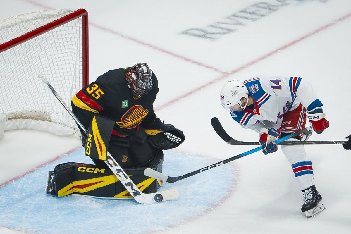 Oct 28, 2025; Vancouver, British Columbia, CAN; Vancouver Canucks goalie Thatcher Demko (35) makes a save on New York Rangers forward Taylor Raddysh (14) in the first period at Rogers Arena. Mandatory Credit: Bob Frid-Imagn Images