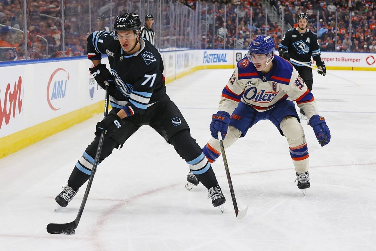 Oct 28, 2025; Edmonton, Alberta, CAN; Utah Mammoth forward JJ Peterka (77) makes a pass in front of Edmonton Oilers forward Ryan Nugent-Hopkins (93) during the second period at Rogers Place. Mandatory Credit: Perry Nelson-Imagn Images