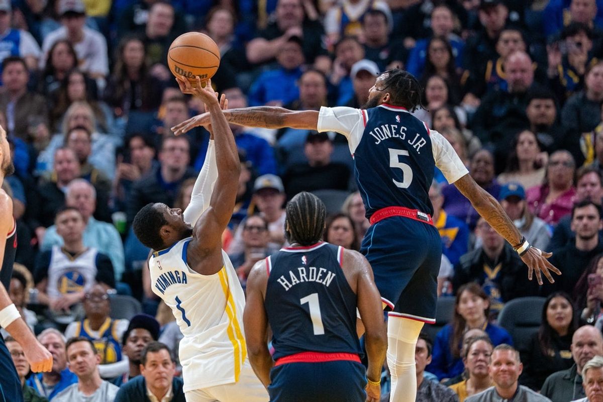 Oct 28, 2025; San Francisco, California, USA; Golden State Warriors forward Jonathan Kuminga (1) shoots the basketball against LA Clippers forward Derrick Jones Jr. (5) during the second quarter at Chase Center. Mandatory Credit: Neville E. Guard-Imagn Images