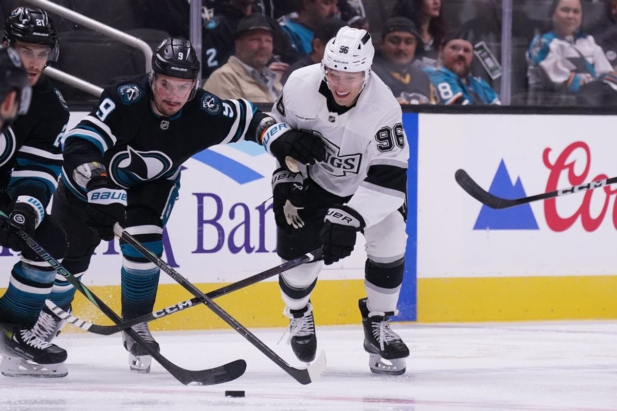 Oct 28, 2025; San Jose, California, USA; San Jose Sharks defenseman Dmitry Orlov (9) and Los Angeles Kings left winger Andrei Kuzmenko (96) battle for the puck in the second period at SAP Center at San Jose. Mandatory Credit: David Gonzales-Imagn Images