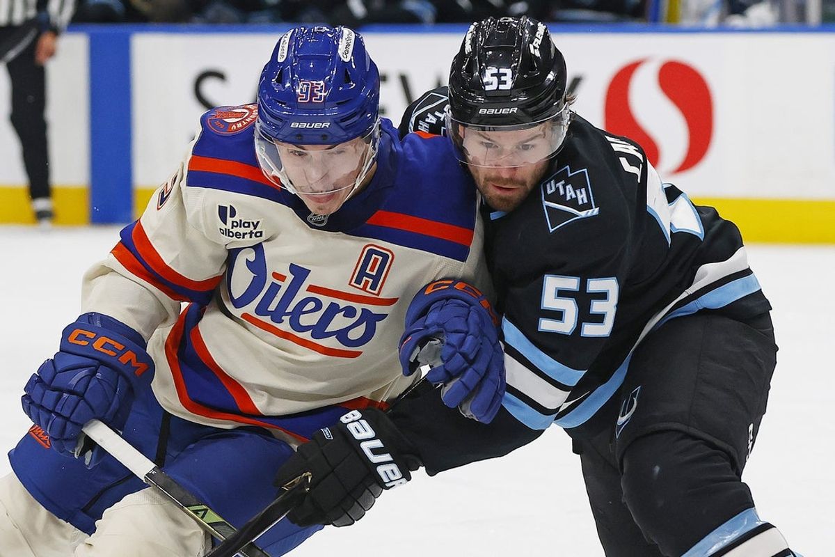 Oct 28, 2025; Edmonton, Alberta, CAN; Edmonton Oilers /forward Ryan Nugent-Hopkins (93) and Utah Mammoth forward Michael Carcone (53) battles for position during the third period at Rogers Place. Mandatory Credit: Perry Nelson-Imagn Images