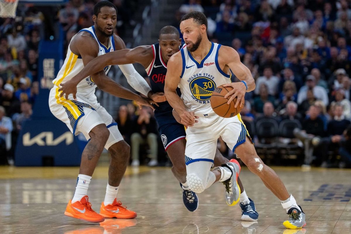 Oct 28, 2025; San Francisco, California, USA; Golden State Warriors guard Stephen Curry (30) dribbles around LA Clippers guard Kris Dunn (8) during the fourth quarter at Chase Center. Mandatory Credit: Neville E. Guard-Imagn Images