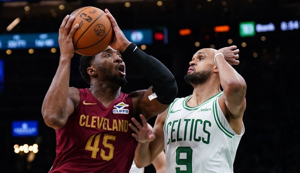 Oct 29, 2025; Boston, Massachusetts, USA; Cleveland Cavaliers guard Donovan Mitchell (45) drives the ball against Boston Celtics guard Derrick White (9) in the second half at TD Garden. Mandatory Credit: David Butler II-Imagn Images