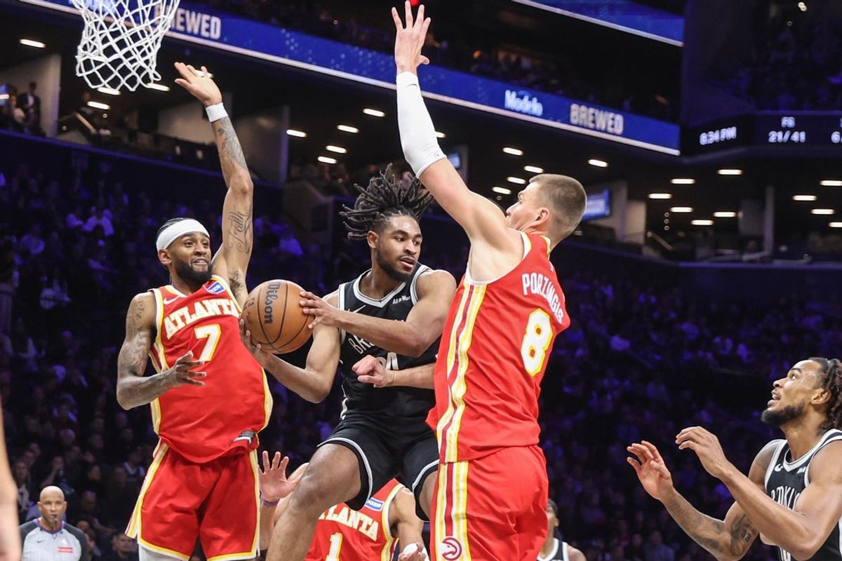 Oct 29, 2025; Brooklyn, New York, USA; Brooklyn Nets guard Cam Thomas (24) is double-teamed by Atlanta Hawks guard Nickeil Alexander-Walker (7) and center Kristaps Porzingis (8) in the second quarter at Barclays Center. Mandatory Credit: Wendell Cruz-Imagn Images