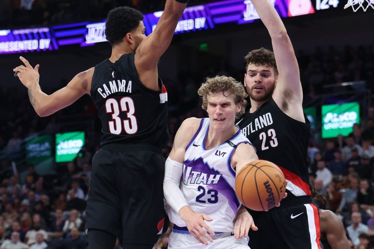 Oct 29, 2025; Salt Lake City, Utah, USA; Utah Jazz forward Lauri Markkanen (23) passes the ball as Portland Trail Blazers forward Toumani Camara (33) and center Donovan Clingan (23) defend during the second half at Delta Center. Mandatory Credit: Rob Gray-Imagn Images