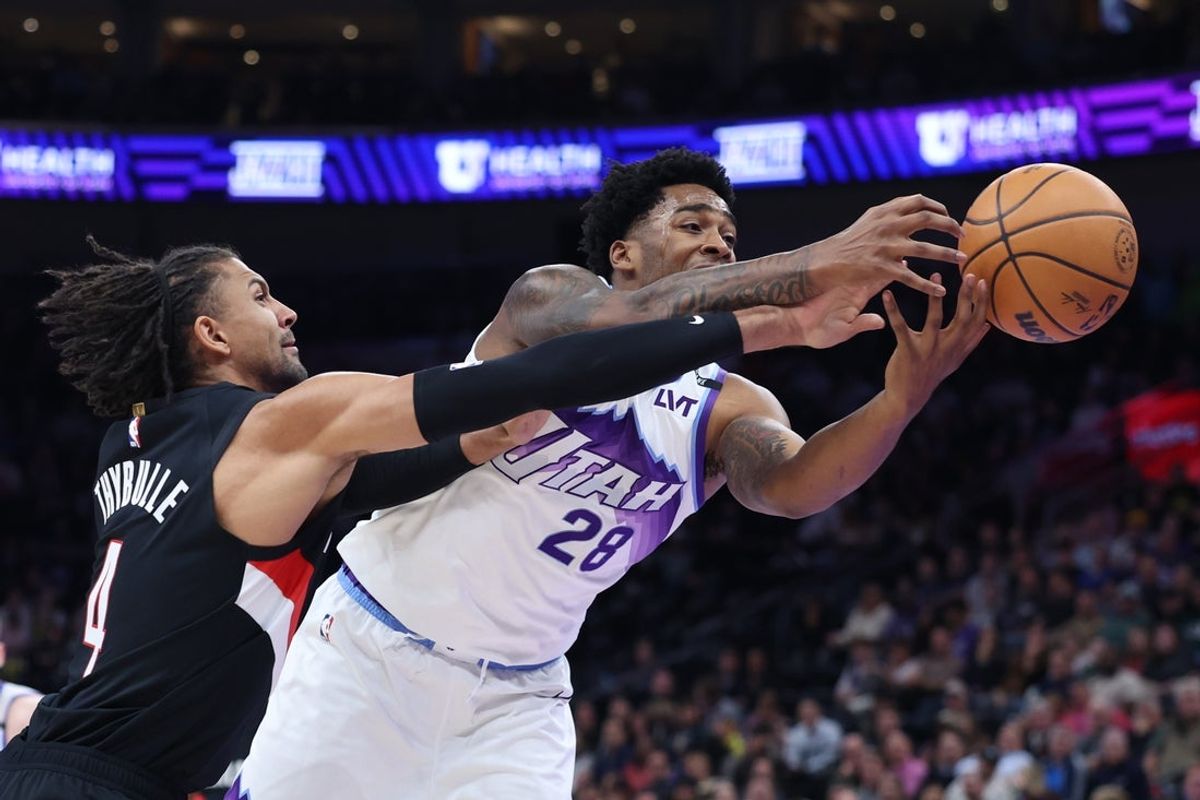 Oct 29, 2025; Salt Lake City, Utah, USA; Portland Trail Blazers guard Matisse Thybulle (4) and Utah Jazz forward Brice Sensabaugh (28) reach for the ball during the first half at Delta Center. Mandatory Credit: Rob Gray-Imagn Images