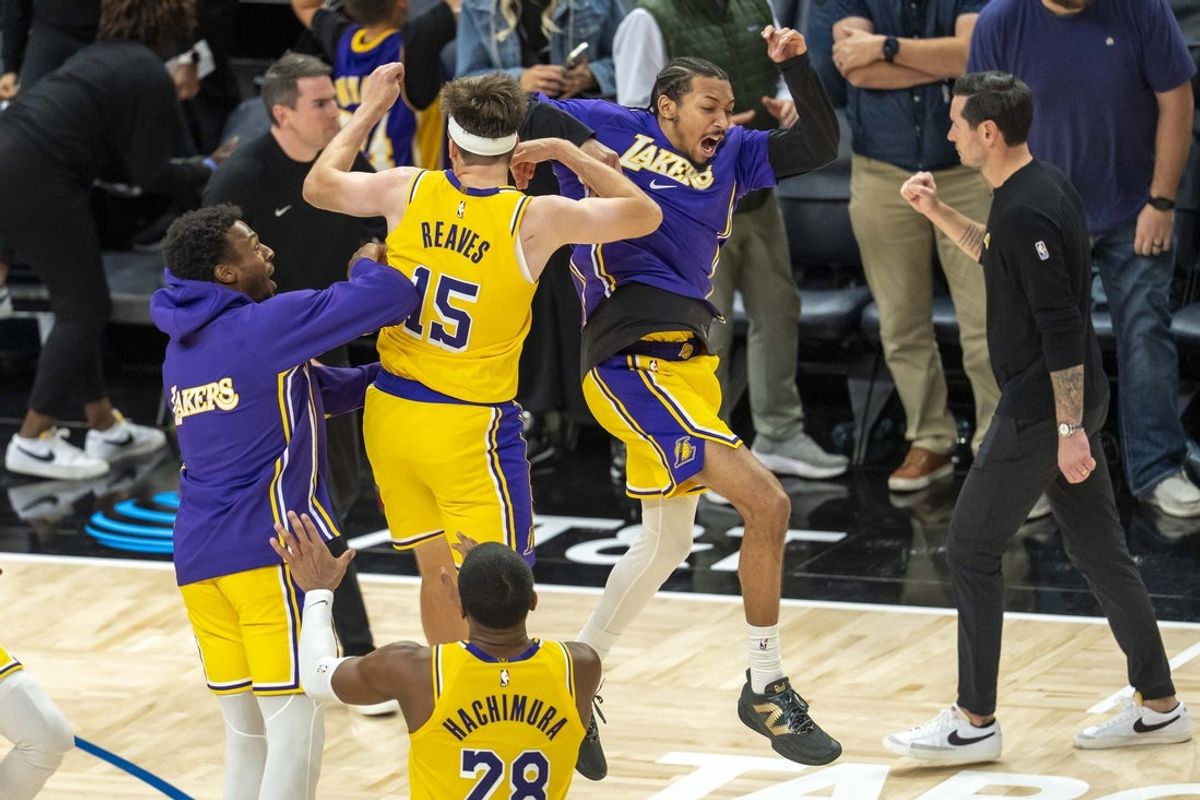 Oct 29, 2025; Minneapolis, Minnesota, USA; Los Angeles Lakers guard Austin Reaves (15) celebrates with guard Bronny James (9) and guard Nick Smith Jr. (20) after making a buzzer beater shot against the Minnesota Timberwolves at Target Center. Mandatory Credit: Jesse Johnson-Imagn Images