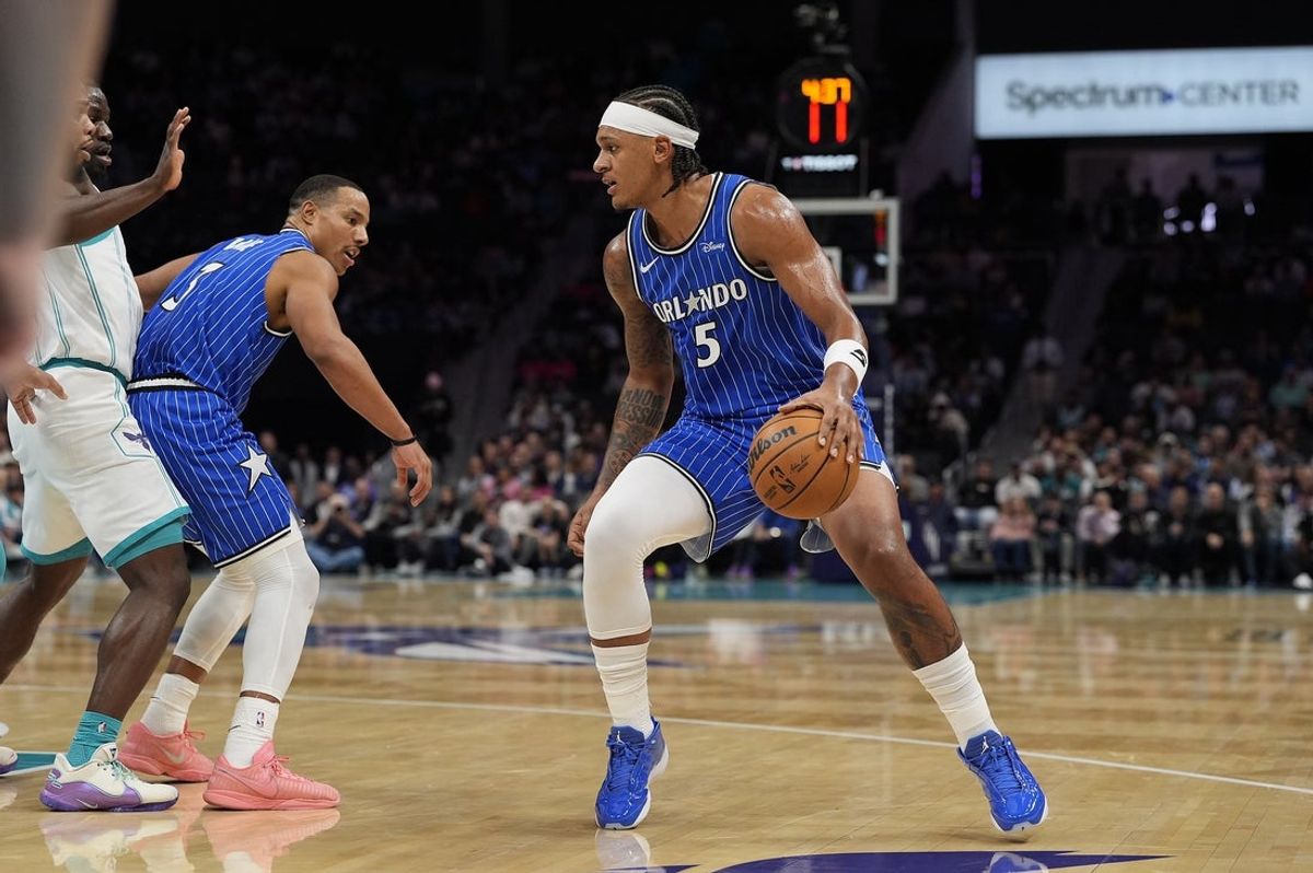 Oct 30, 2025; Charlotte, North Carolina, USA; Orlando Magic forward Paolo Banchero (5) handles the ball against the Charlotte Hornets during the first quarter at Spectrum Center. Mandatory Credit: Jim Dedmon-Imagn Images