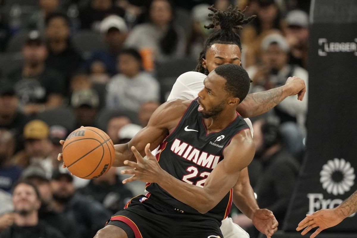 Oct 30, 2025; San Antonio, Texas, USA; Miami Heat forward Andrew Wiggins (22) drives to the basket against San Antonio Spurs guard Stephon Castle (5) during the first half at Frost Bank Center. Mandatory Credit: Scott Wachter-Imagn Images