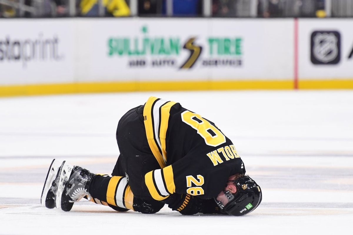 Oct 30, 2025; Boston, Massachusetts, USA; Boston Bruins center Elias Lindholm (28) on the ice after an apparent injury during the second period against the Buffalo Sabres at TD Garden. Mandatory Credit: Bob DeChiara-Imagn Images
