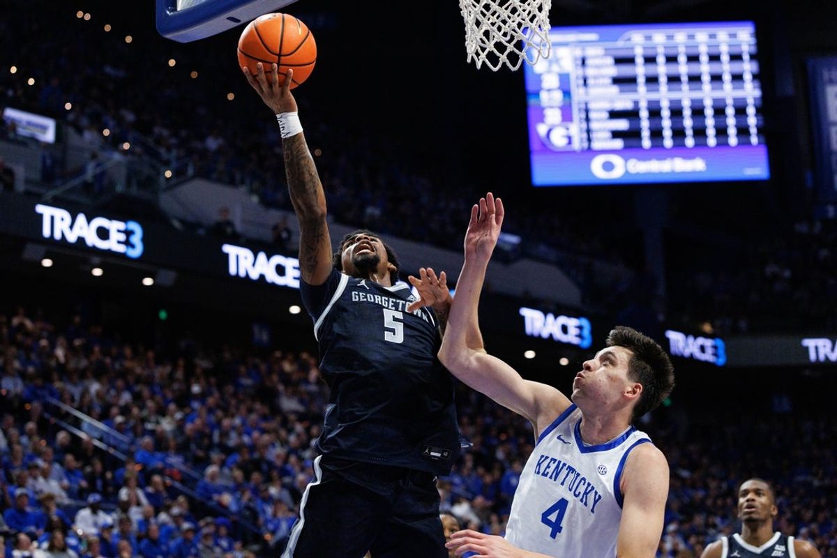 Oct 30, 2025; Lexington, KY, USA; Georgetown Hoyas guard Kj Lewis (5) goes to the basket against Kentucky Wildcats forward Andrija Jelavic (4) during the first half at Rupp Arena at Central Bank Center. Mandatory Credit: Jordan Prather-Imagn Images