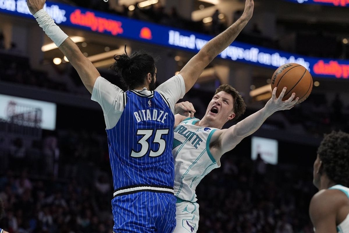 Oct 30, 2025; Charlotte, North Carolina, USA; Charlotte Hornets guard Kon Knueppel (7) drives to the basket against Orlando Magic center Goga Bitadze (35) during the second half at Spectrum Center. Mandatory Credit: Jim Dedmon-Imagn Images