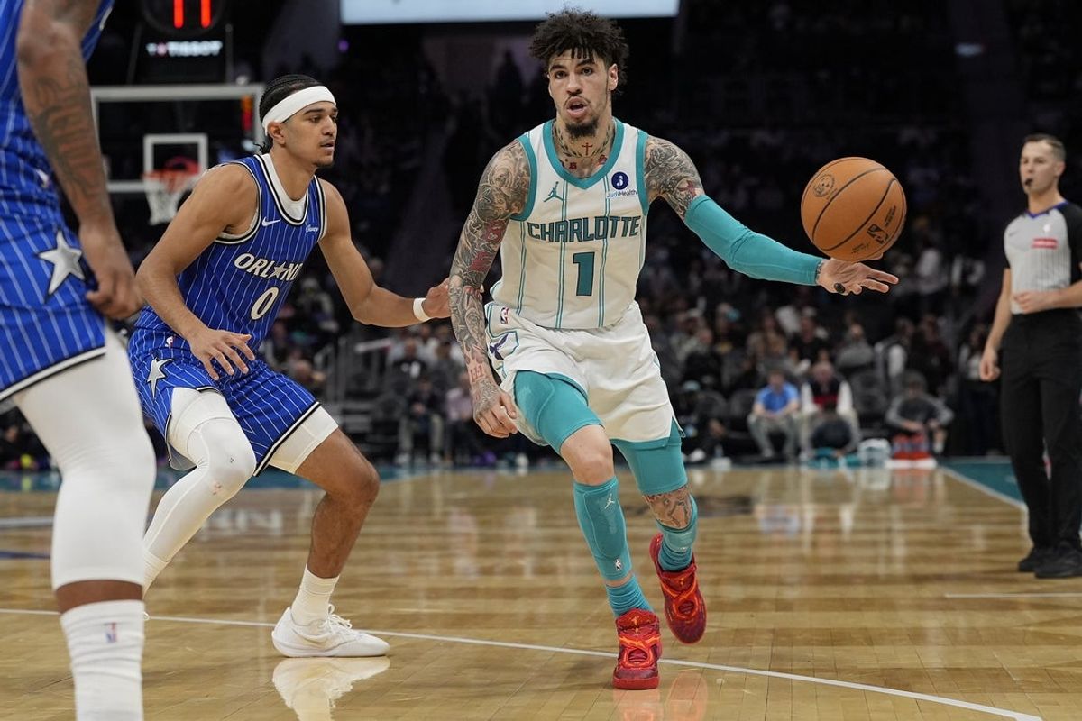 Oct 30, 2025; Charlotte, North Carolina, USA; Charlotte Hornets guard LaMelo Ball (1) handles the ball defended by Orlando Magic guard Anthony Black during the second half at Spectrum Center. Mandatory Credit: Jim Dedmon-Imagn Images