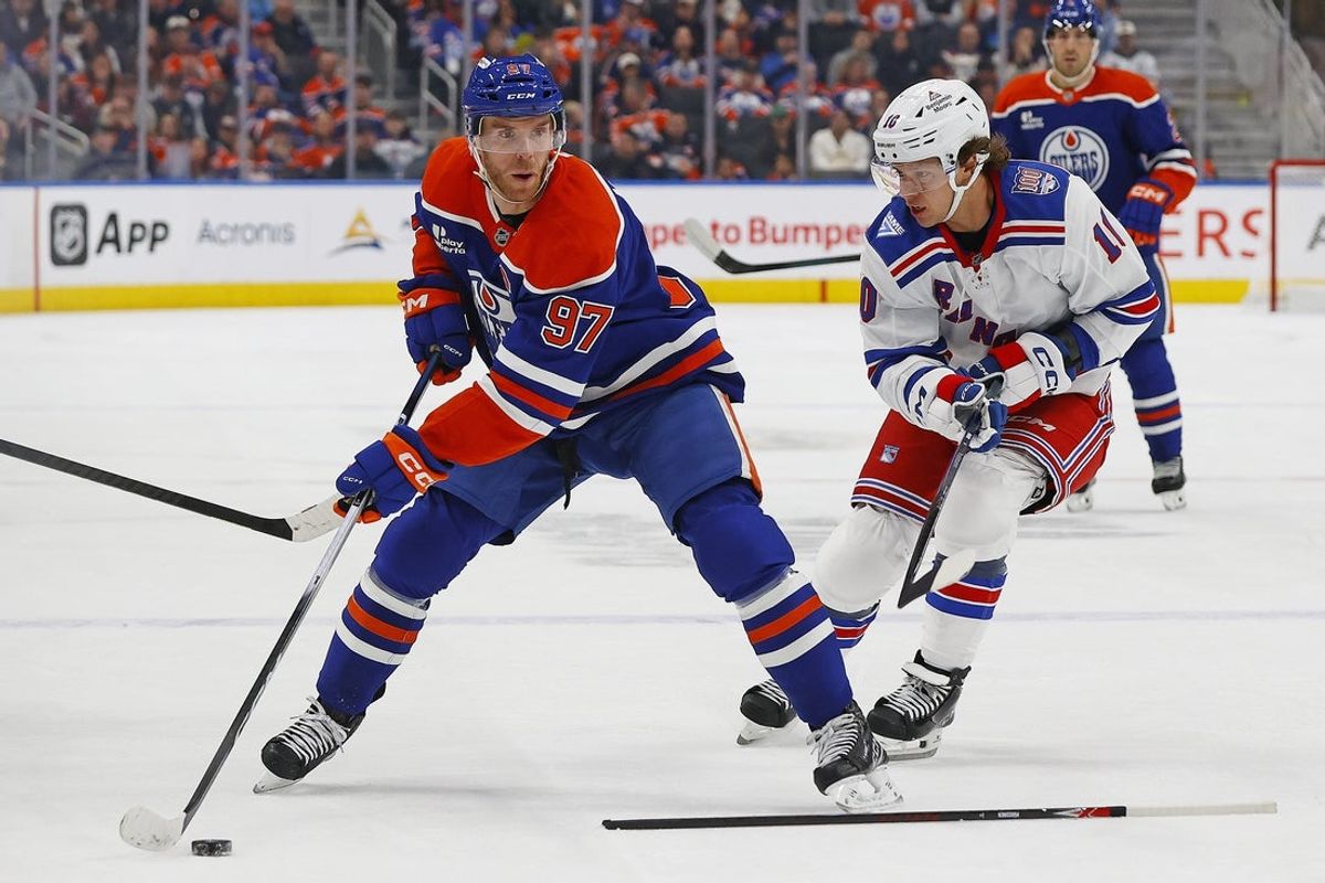 Oct 30, 2025; Edmonton, Alberta, CAN; Edmonton Oilers forward Connor McDavid (97) looks to make a pass in front of New York Rangers forward Artemi Panarin (10) during the first period at Rogers Place. Mandatory Credit: Perry Nelson-Imagn Images