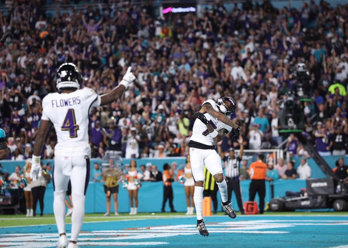 Oct 30, 2025; Miami Gardens, Florida, USA;  Baltimore Ravens wide receiver Rashod Bateman (7) and wide receiver Zay Flowers (4) celebrate a touchdown during the third quarter against the Miami Dolphins at Hard Rock Stadium. Mandatory Credit: Nathan Ray Seebeck-Imagn Images