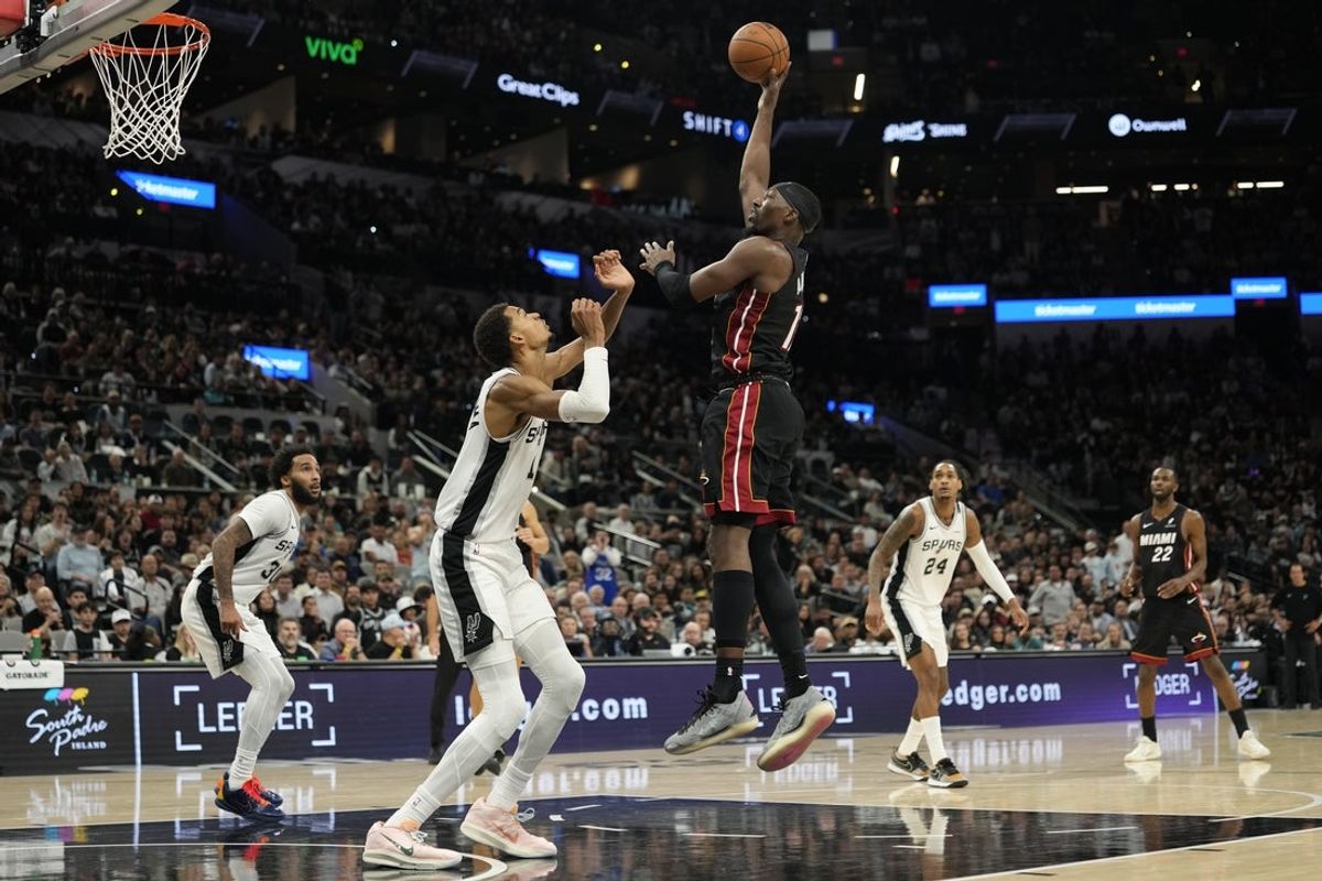 Oct 30, 2025; San Antonio, Texas, USA; Miami Heat forward Bam Adebayo (13) shoots over San Antonio Spurs forward Victor Wembanyama (1) during the second half at Frost Bank Center. Mandatory Credit: Scott Wachter-Imagn Images